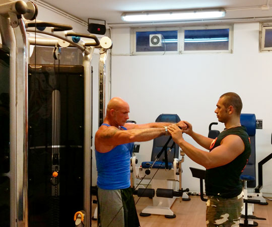Il Personal Trainer Francesco Zonno mentre segue un associato durante un esercizio con la Functional Trainer